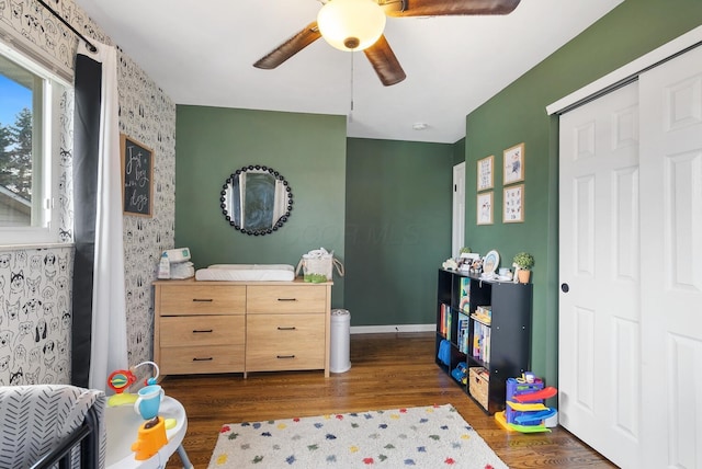 bedroom with ceiling fan, baseboards, and wood finished floors