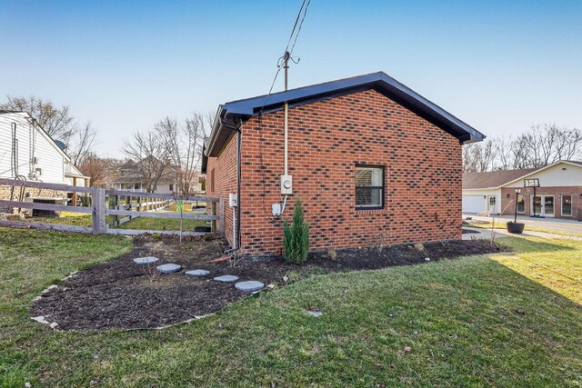 1545 E Choctaw Dr, London, OH 43140 - view of home's exterior featuring brick siding, fence, and a lawn