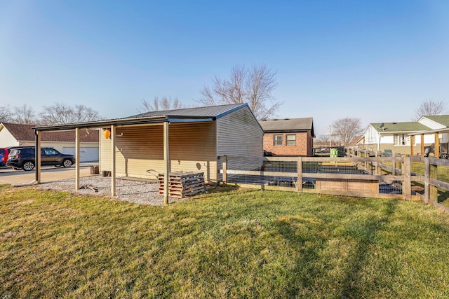 1545 E Choctaw Dr, London, OH 43140 - view of property exterior with metal roof, a lawn, and fence