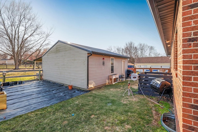 1545 E Choctaw Dr, London, OH 43140 - view of property exterior with brick siding, metal roof, a yard, and fence