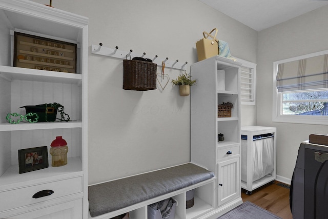 mudroom featuring dark wood finished floors and baseboards