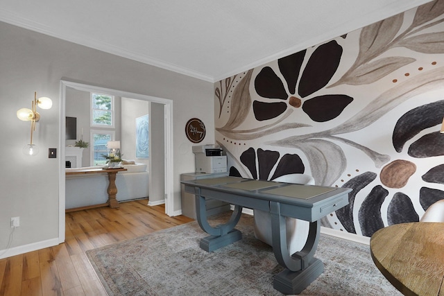 interior space featuring wood-type flooring, ornamental molding, and baseboards