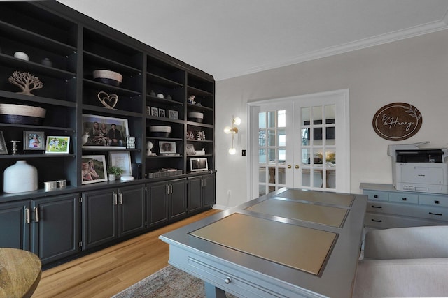 office space featuring light wood-type flooring, ornamental molding, and french doors