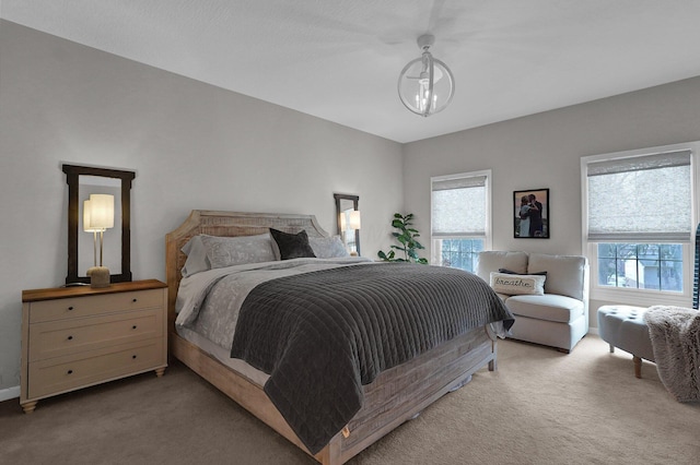 bedroom with baseboards and light colored carpet