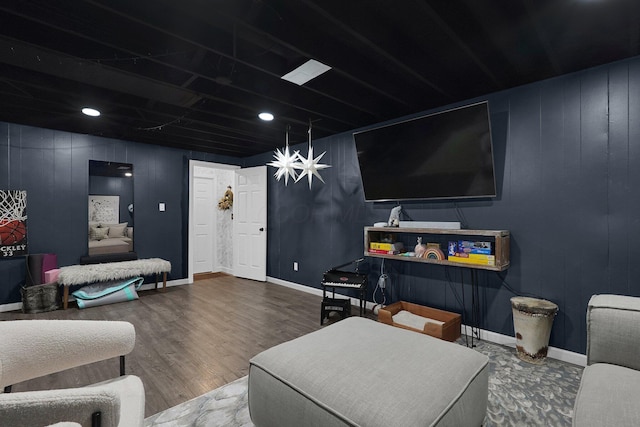 living area with baseboards and wood finished floors