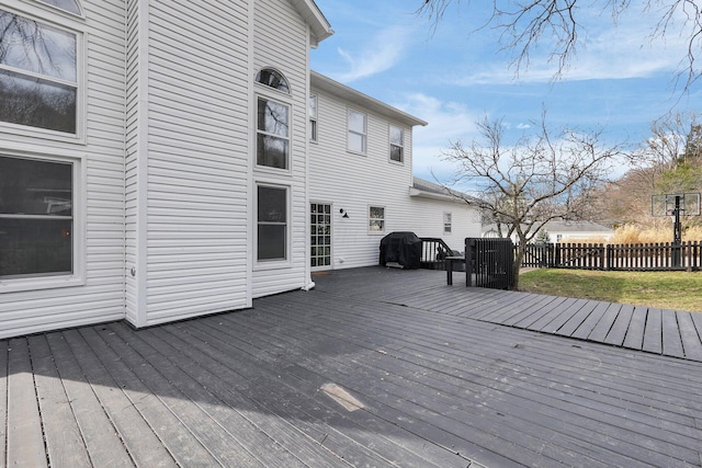 wooden deck with fence and a lawn