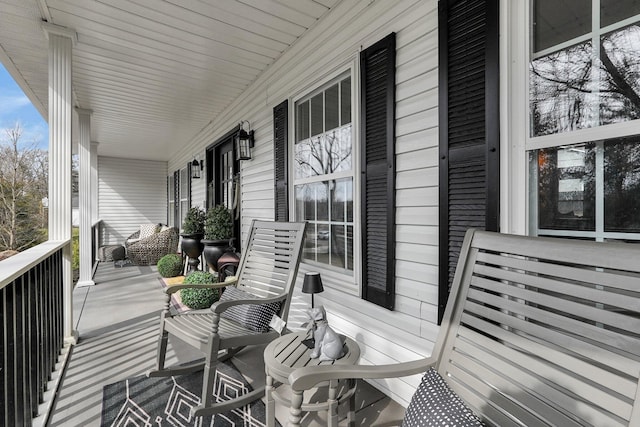 wooden terrace featuring covered porch