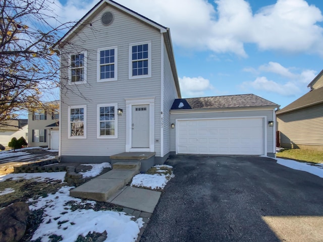 view of front facade featuring aphalt driveway and a garage