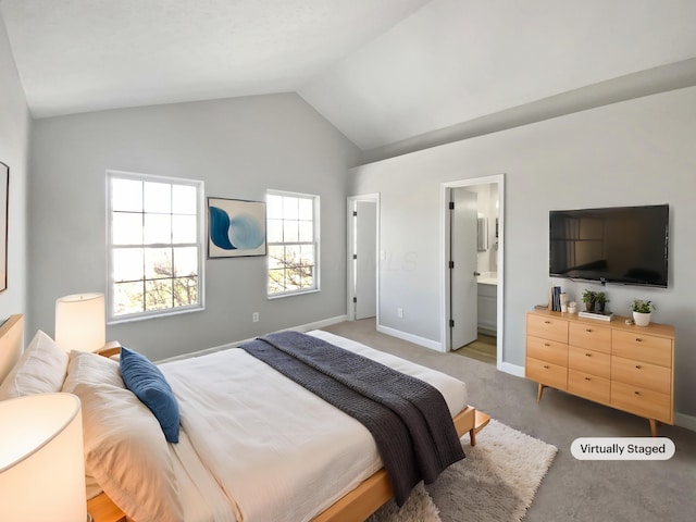 carpeted bedroom featuring baseboards, vaulted ceiling, and ensuite bathroom