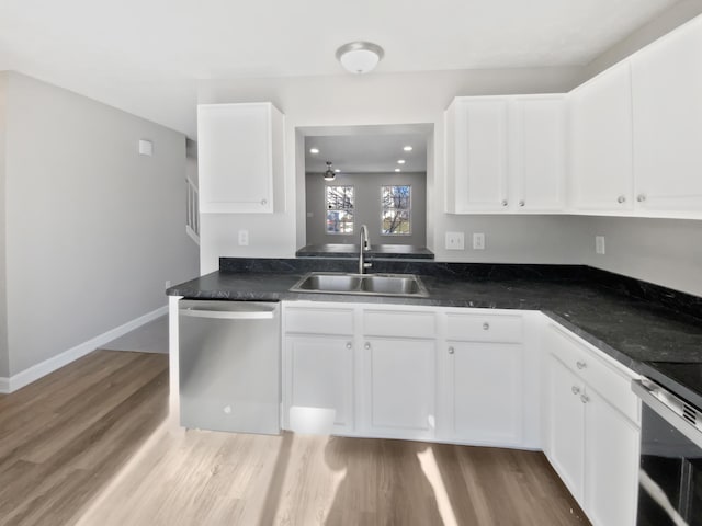 kitchen featuring dishwasher, a sink, white cabinetry, and light wood-style floors