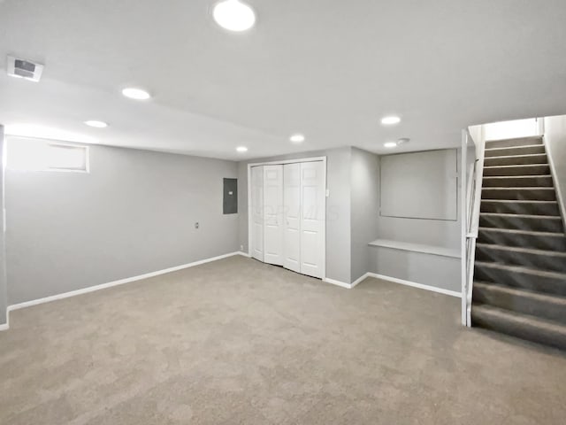 basement with carpet, visible vents, electric panel, baseboards, and stairs