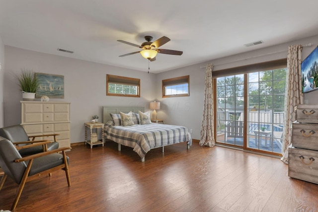 bedroom featuring baseboards, access to outside, visible vents, and wood finished floors