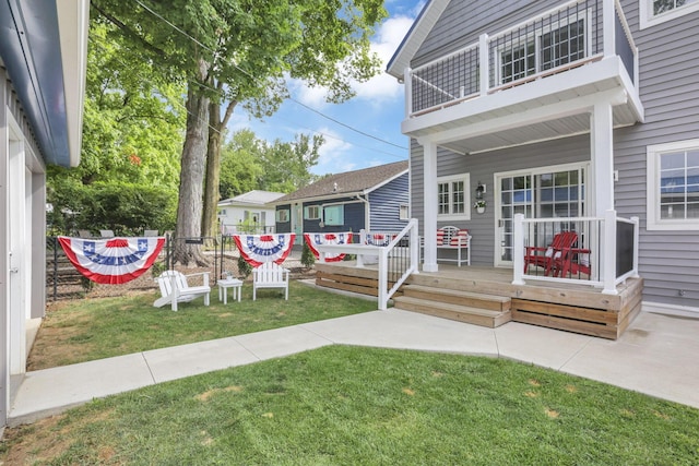 exterior space featuring covered porch, a yard, and a balcony