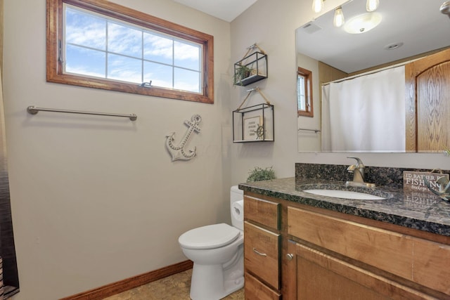 bathroom with baseboards, visible vents, toilet, a shower with curtain, and vanity