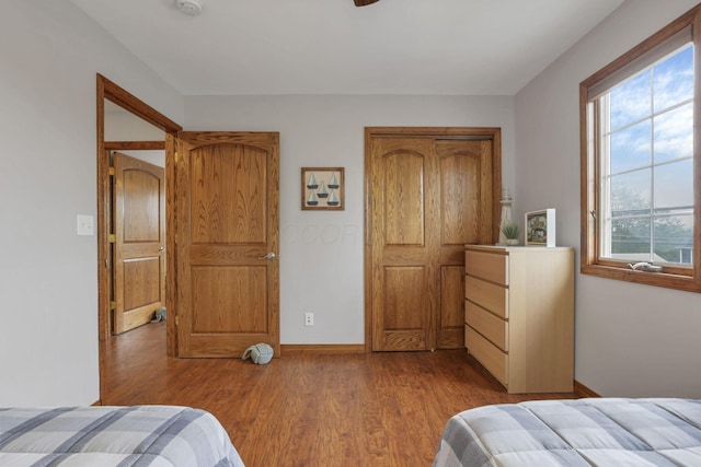 bedroom with baseboards and wood finished floors