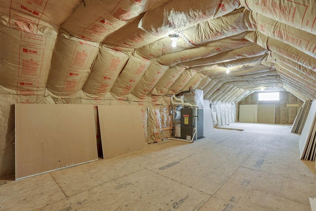 unfinished attic featuring heating unit