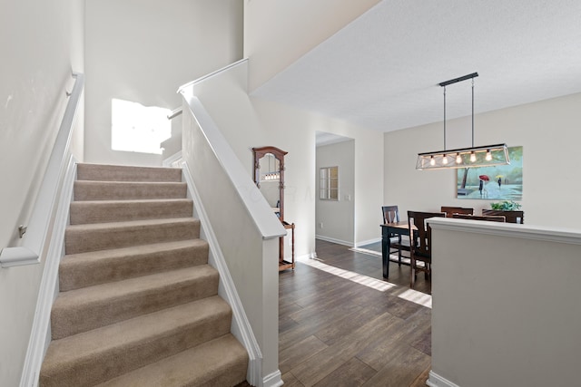 stairs featuring hardwood / wood-style floors