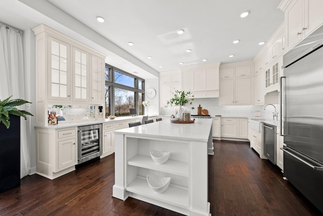 kitchen featuring backsplash, a center island, wine cooler, stainless steel appliances, and open shelves