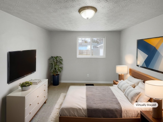 carpeted bedroom featuring a textured ceiling