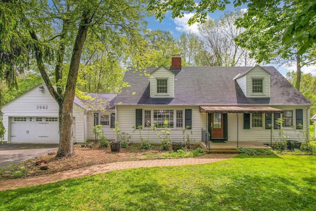 cape cod home with a front lawn, driveway, an attached garage, and a chimney