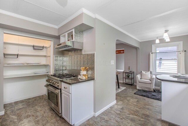 kitchen with high end stove, arched walkways, ornamental molding, baseboards, and open shelves