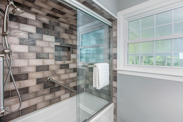 bathroom featuring shower / bath combination with glass door and healthy amount of natural light