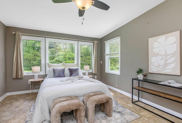 bedroom with baseboards, lofted ceiling, and a ceiling fan
