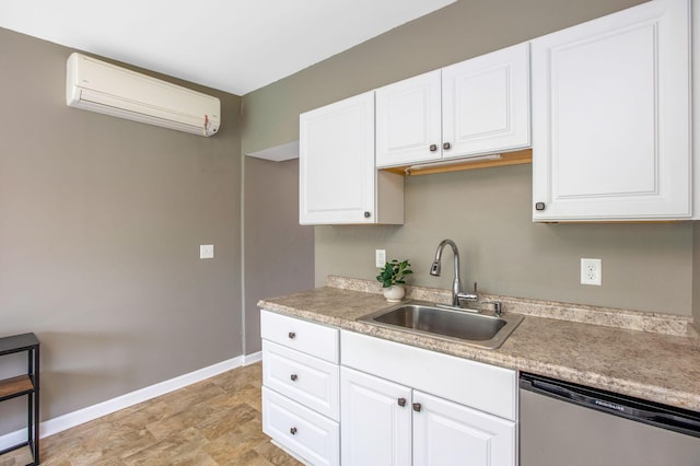 kitchen featuring dishwasher, a wall mounted AC, baseboards, a sink, and white cabinetry