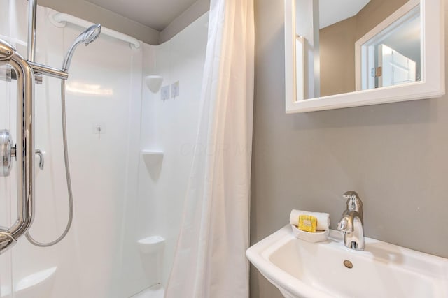 bathroom with a sink and a shower with shower curtain