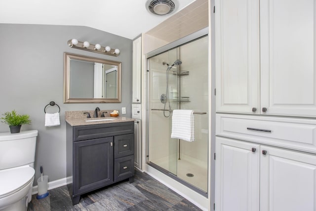 full bathroom featuring a shower stall, toilet, vanity, and baseboards