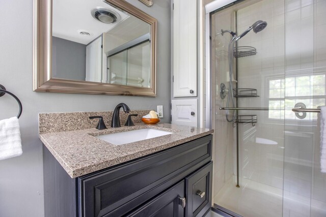bathroom featuring a stall shower and vanity
