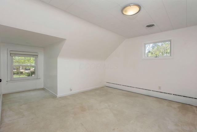 bonus room with a baseboard radiator, carpet, vaulted ceiling, and baseboards