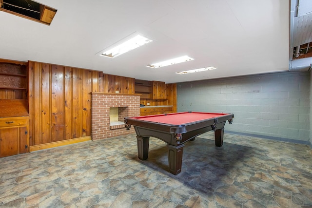 playroom featuring stone finish flooring, billiards table, and wood walls