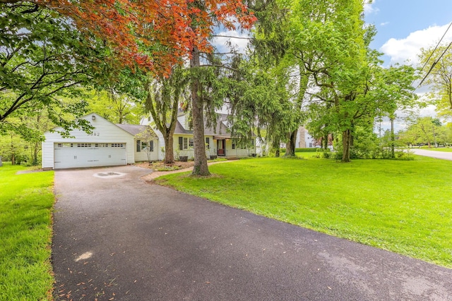 view of front of home featuring driveway, an attached garage, and a front yard