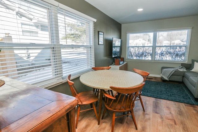 dining space with a healthy amount of sunlight and light hardwood / wood-style flooring