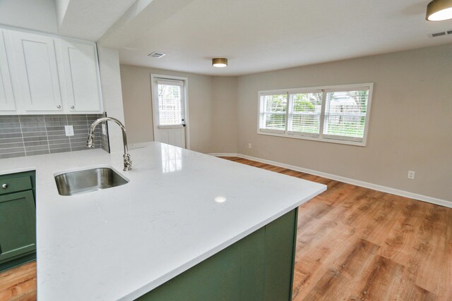 189 N Gould Rd, Bexley, OH 43209 - kitchen featuring green cabinets, a sink, light countertops, white cabinetry, and backsplash