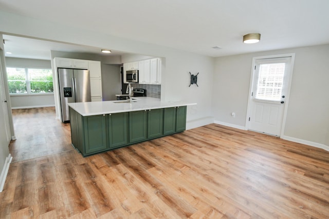 189 N Gould Rd, Bexley, OH 43209 - kitchen with green cabinets, appliances with stainless steel finishes, a sink, a peninsula, and white cabinetry