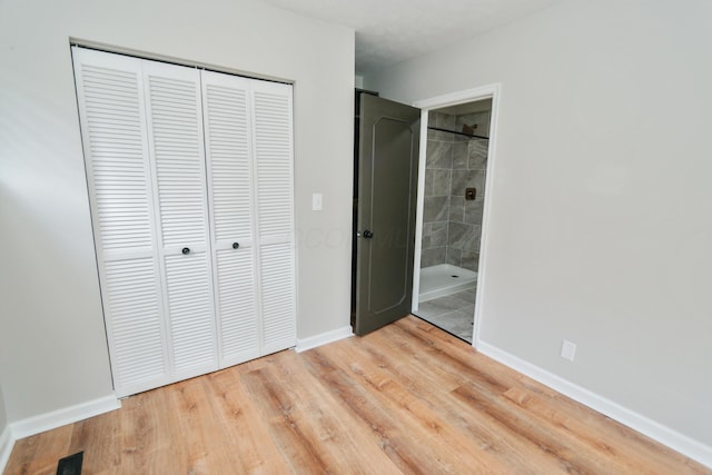 189 N Gould Rd, Bexley, OH 43209 - unfurnished bedroom with a closet, light wood-style floors, baseboards, and connected bathroom
