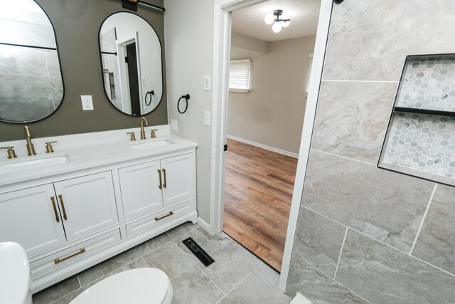 189 N Gould Rd, Bexley, OH 43209 - bathroom featuring toilet, double vanity, baseboards, and tile patterned flooring