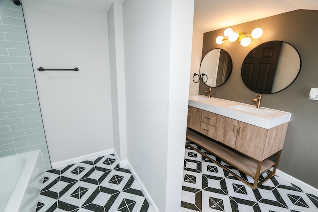 189 N Gould Rd, Bexley, OH 43209 - bathroom featuring a bath, double vanity, and baseboards