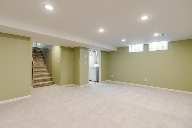 basement featuring washer / clothes dryer and light colored carpet