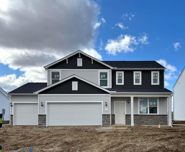 view of front of property featuring stone siding, dirt driveway, and an attached garage