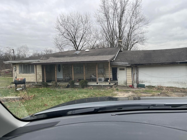 single story home with covered porch and a garage