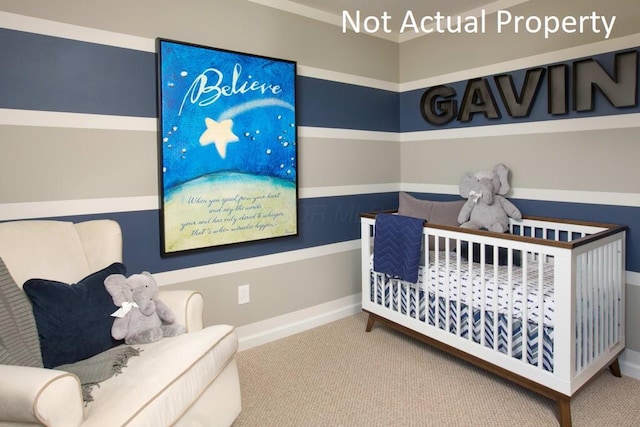 carpeted bedroom featuring baseboards