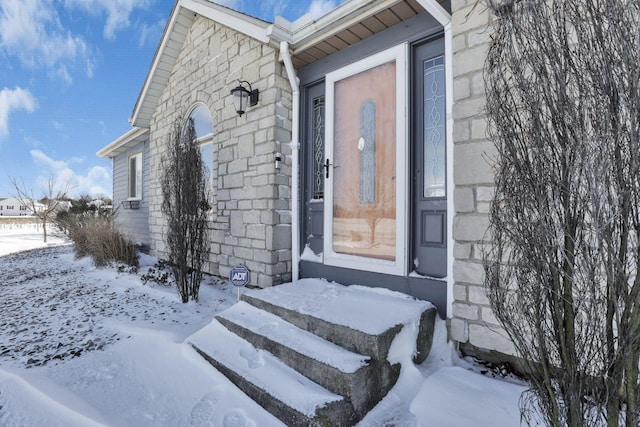 view of snow covered property entrance