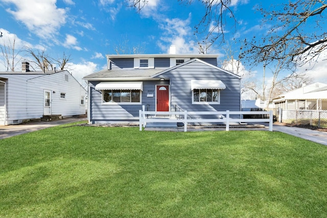 view of front of property with a fenced front yard, a chimney, and a front yard