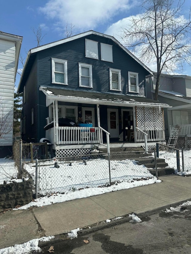 view of front of house with covered porch and a fenced front yard