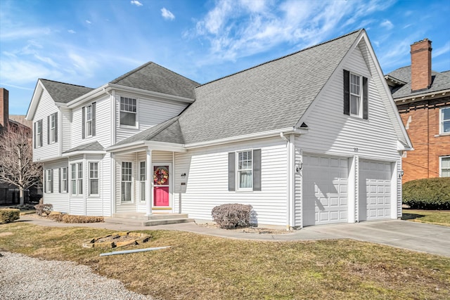 traditional home featuring concrete driveway, roof with shingles, an attached garage, and a front yard