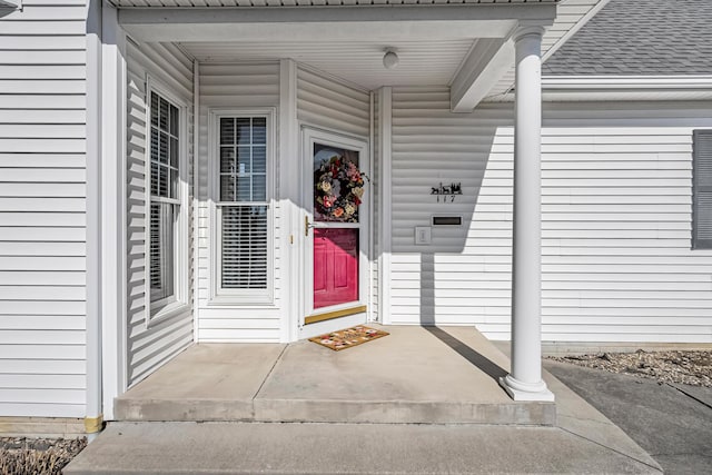 property entrance with roof with shingles