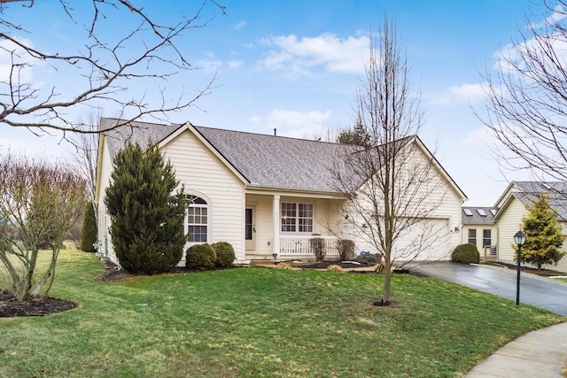 single story home with a porch, a shingled roof, a garage, driveway, and a front lawn